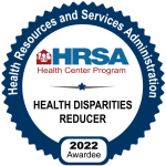 The HRSA Health Disparities Reducer logo. It says, "Health Resources and Services Administration. HRSA Health Center Program. Health Disparities Reducer. 2022 Awardee.